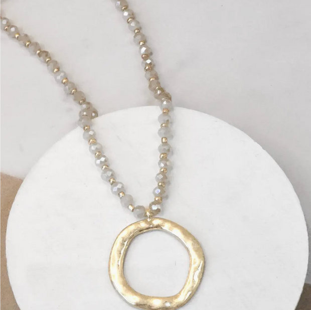 Beaded long necklace with gold circle pendant 