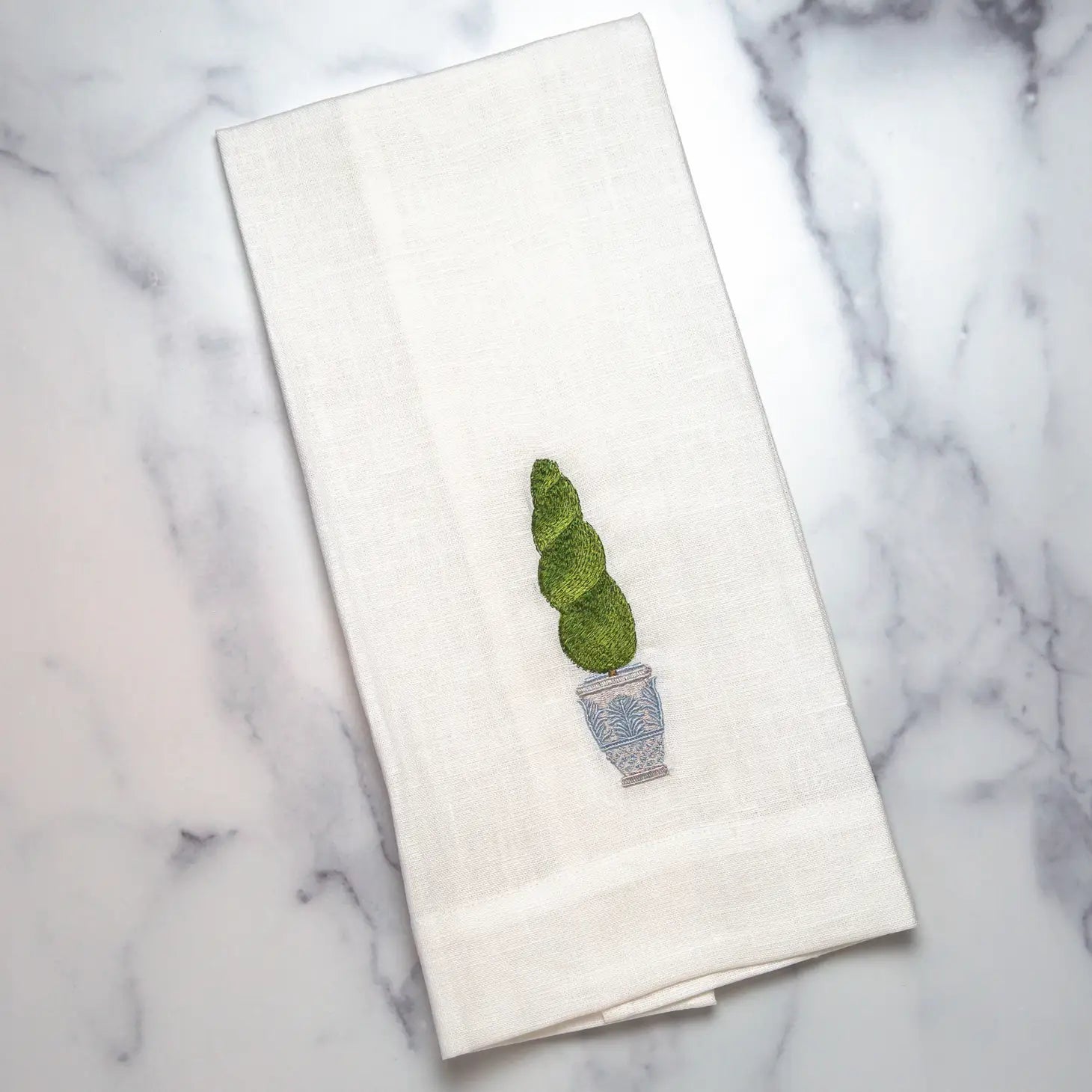Embroidered Towel that is embroidered with tree topiary