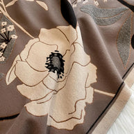 Luxurious reversible tan and gray Garden Bloom Wrap featuring elegant floral patterns and soft fabric.