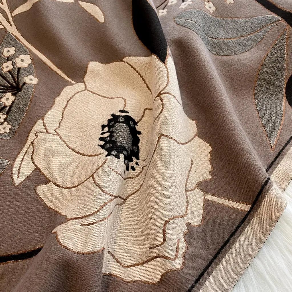 Luxurious reversible tan and gray Garden Bloom Wrap featuring elegant floral patterns and soft fabric.
