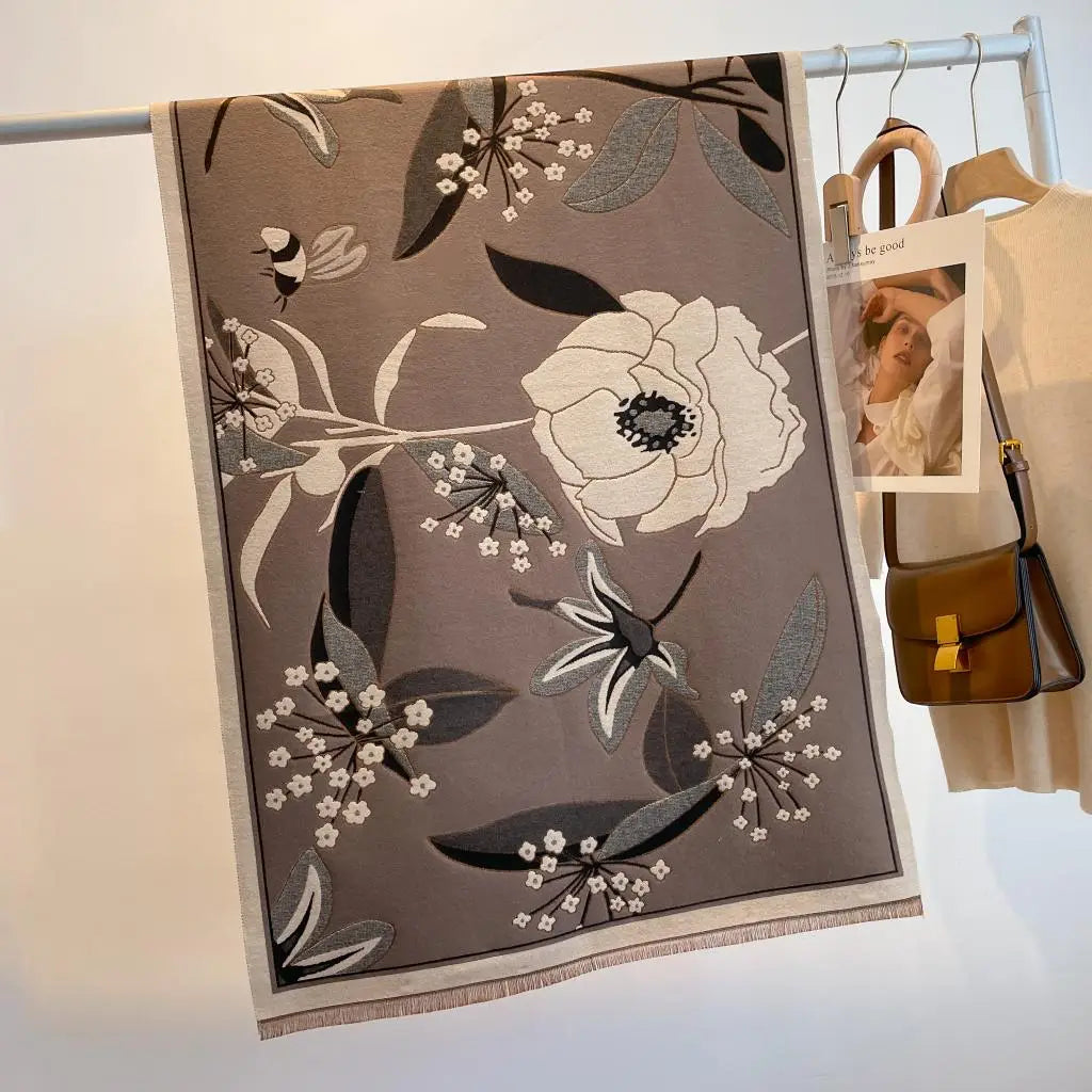 Luxurious reversible tan and gray garden bloom wrap hanging with floral design, perfect for layering and elegant outfits.