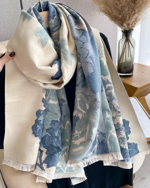 Luxurious reversible blue and cream wrap with floral design, perfect for elevating any outfit.