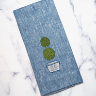 Blue linen towel with boxwood topiary