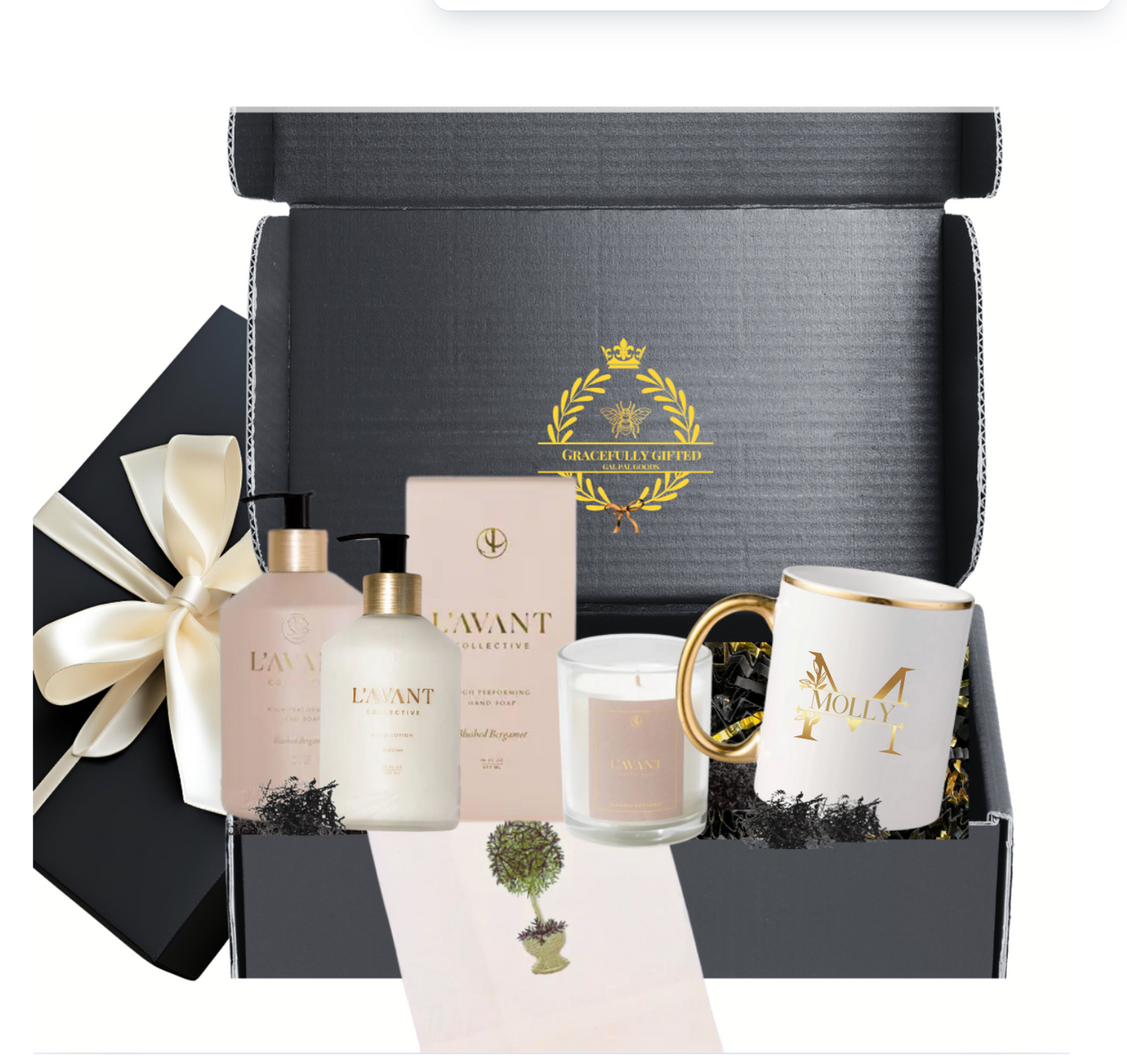 Elegant gift box with L'AVANT hand soap, lotion, candle, and personalized coffee mug, perfect for self-care.