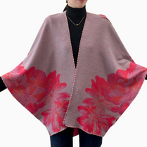 Floral patterned poncho with red flowers on a plain background