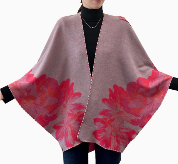 Floral patterned poncho with red flowers on a plain background