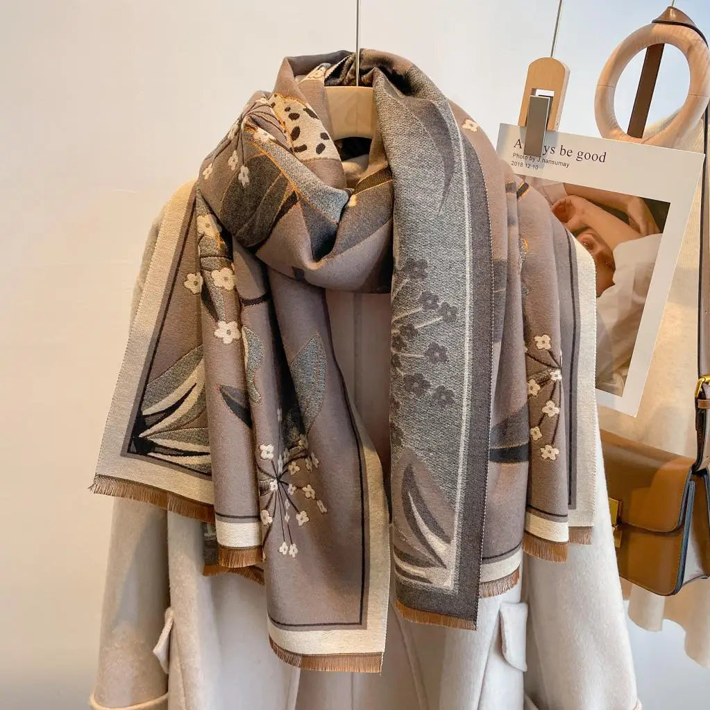 Luxurious reversible tan and gray Garden Bloom Wrap elegantly draped on a coat for a sophisticated layered look.