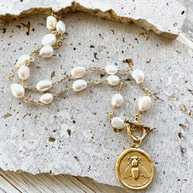 Gold colored chain and fresh water pearl necklace with bee pendant