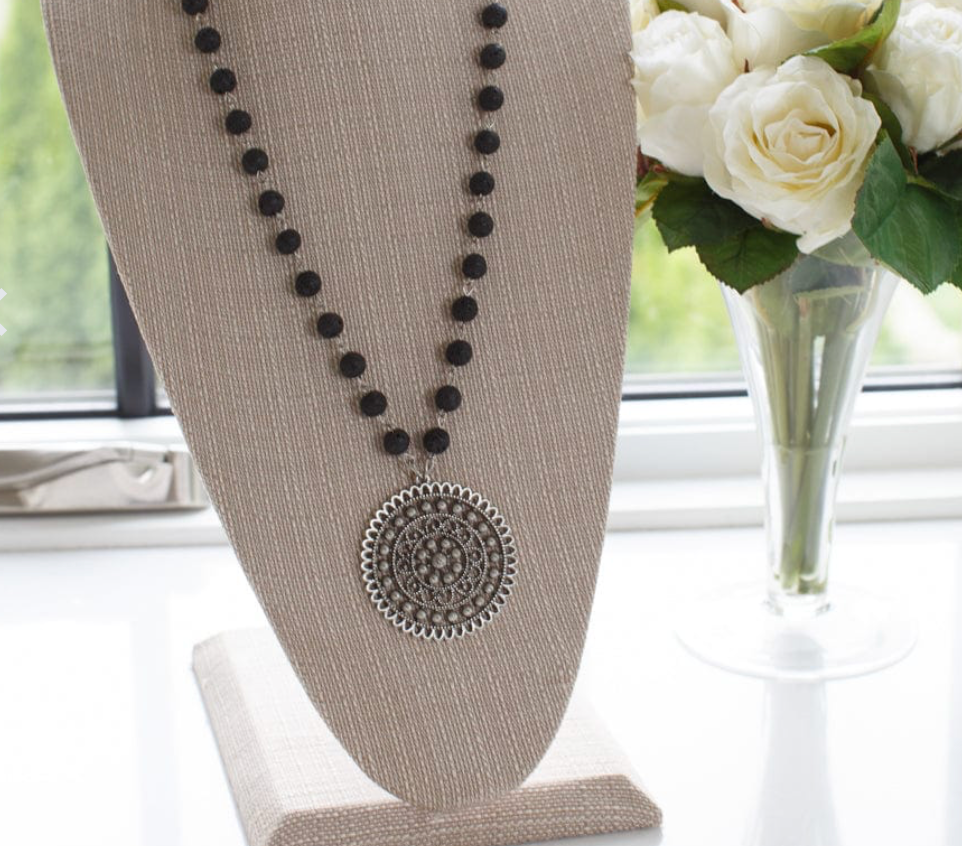 This timeless piece features a long pendant fashioned from beautiful black stone for an elegant touch. Wear it to dress up any look - it pairs flawlessly with jeans or one of our dresses. necklace in display