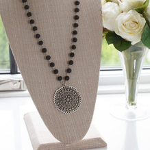 This timeless piece features a long pendant fashioned from beautiful black stone for an elegant touch. Wear it to dress up any look - it pairs flawlessly with jeans or one of our dresses. necklace in display